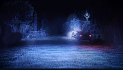 a car driving down a dark road at night