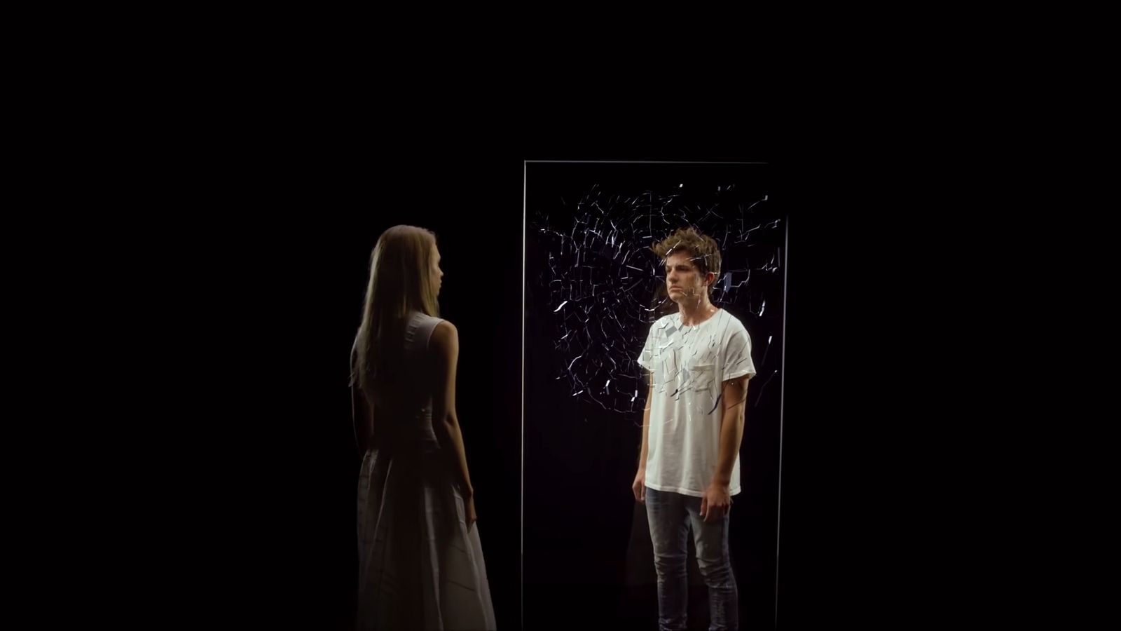a man and a woman standing in front of a mirror