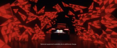 a car driving through a tunnel of red lights