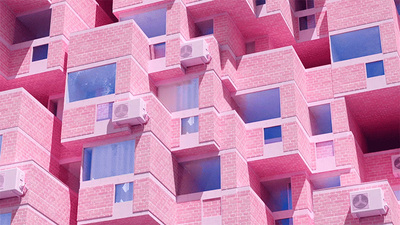 a pink building with multiple balconies and windows