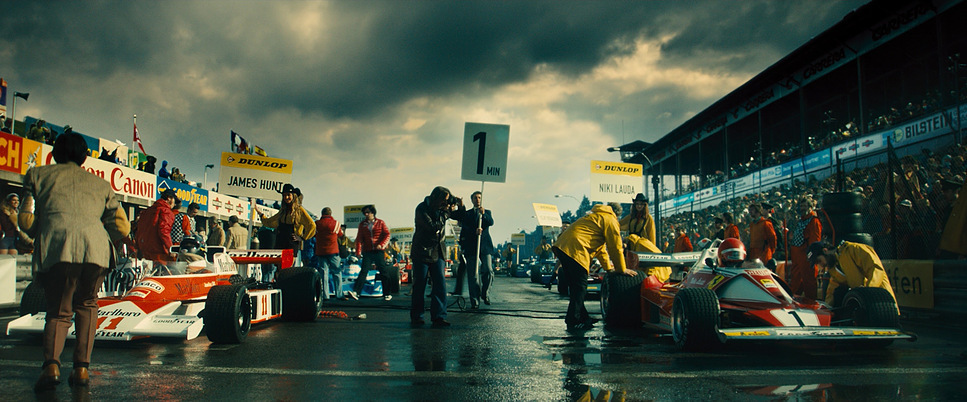 a group of people standing around a race car