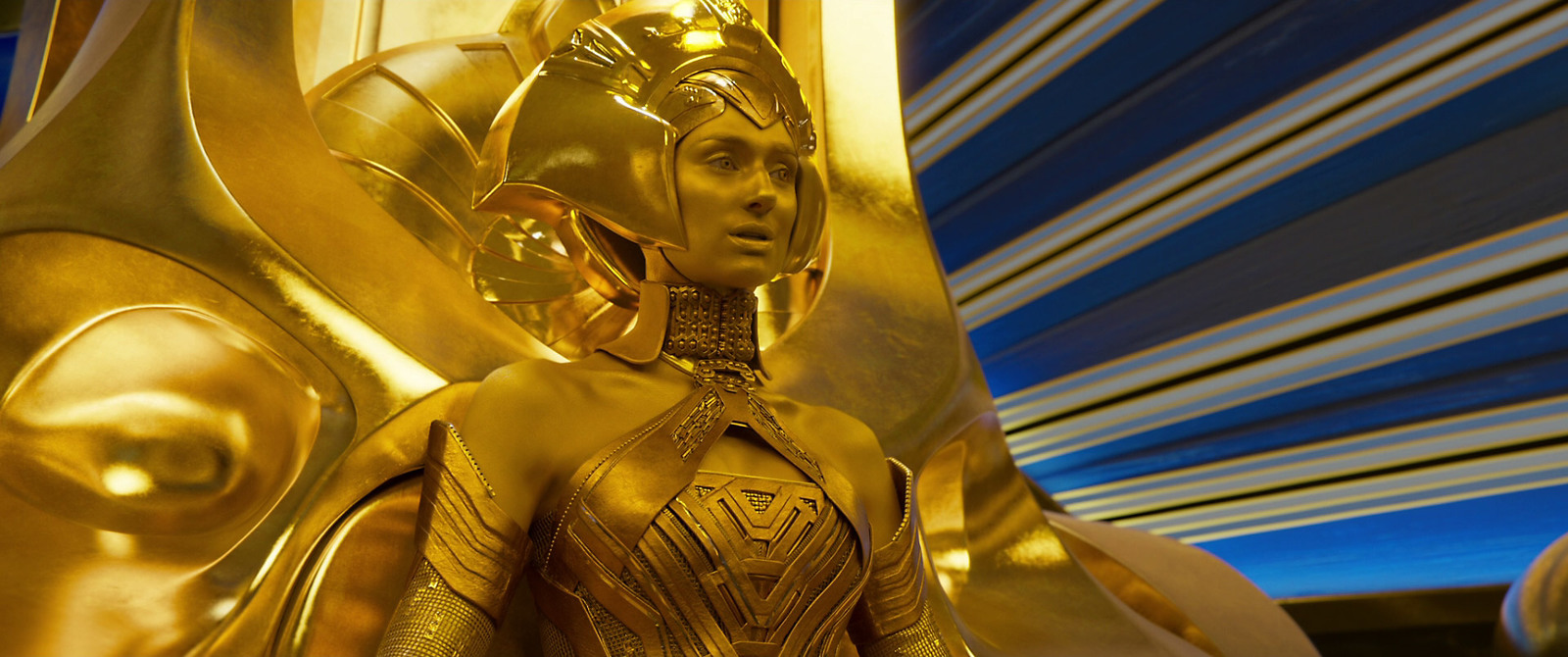 a gold statue of a woman in a golden outfit