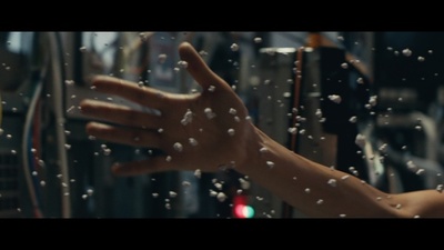 a hand reaching out of a window with water droplets on it