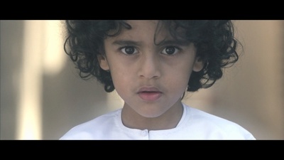 a close up of a child with curly hair