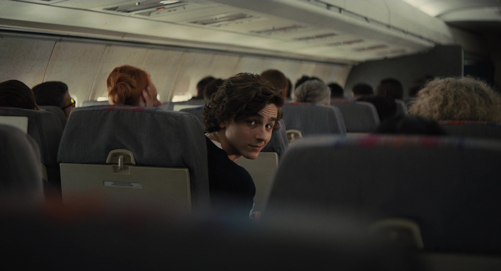 a woman sitting in a seat on an airplane