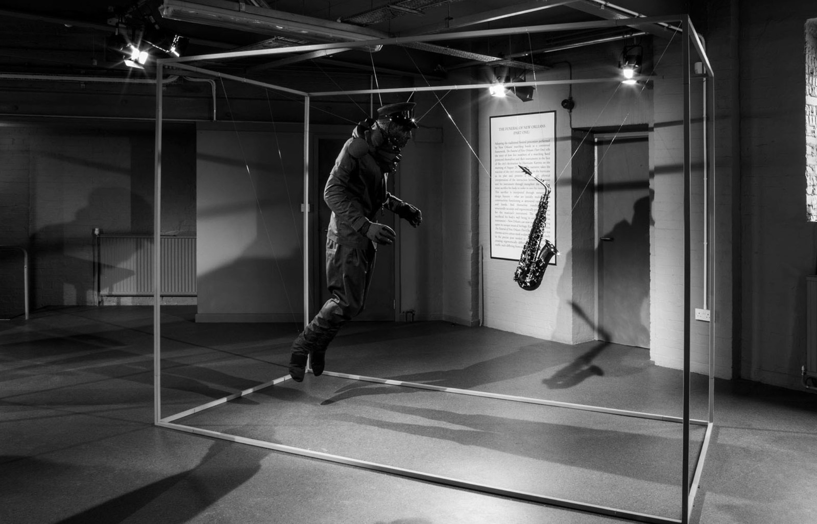 a man standing in a room with a saxophone