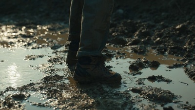 a person standing in a puddle of mud