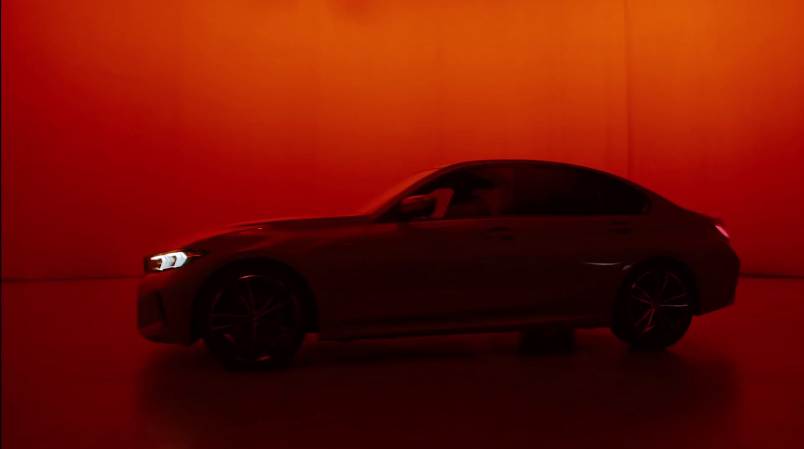 a car in a dark room with a red background