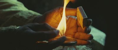 a person holding a lighter in their hands