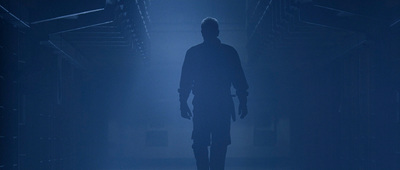 a man standing alone in a dark room