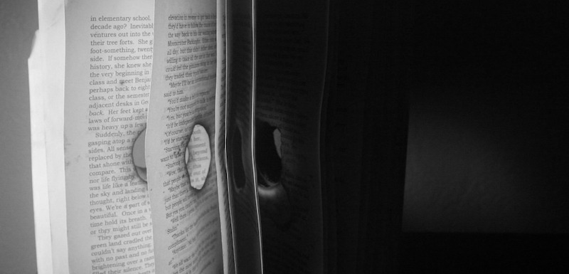 a close up of an open book with pages missing