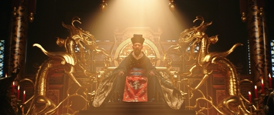 a woman sitting on a throne in a dark room