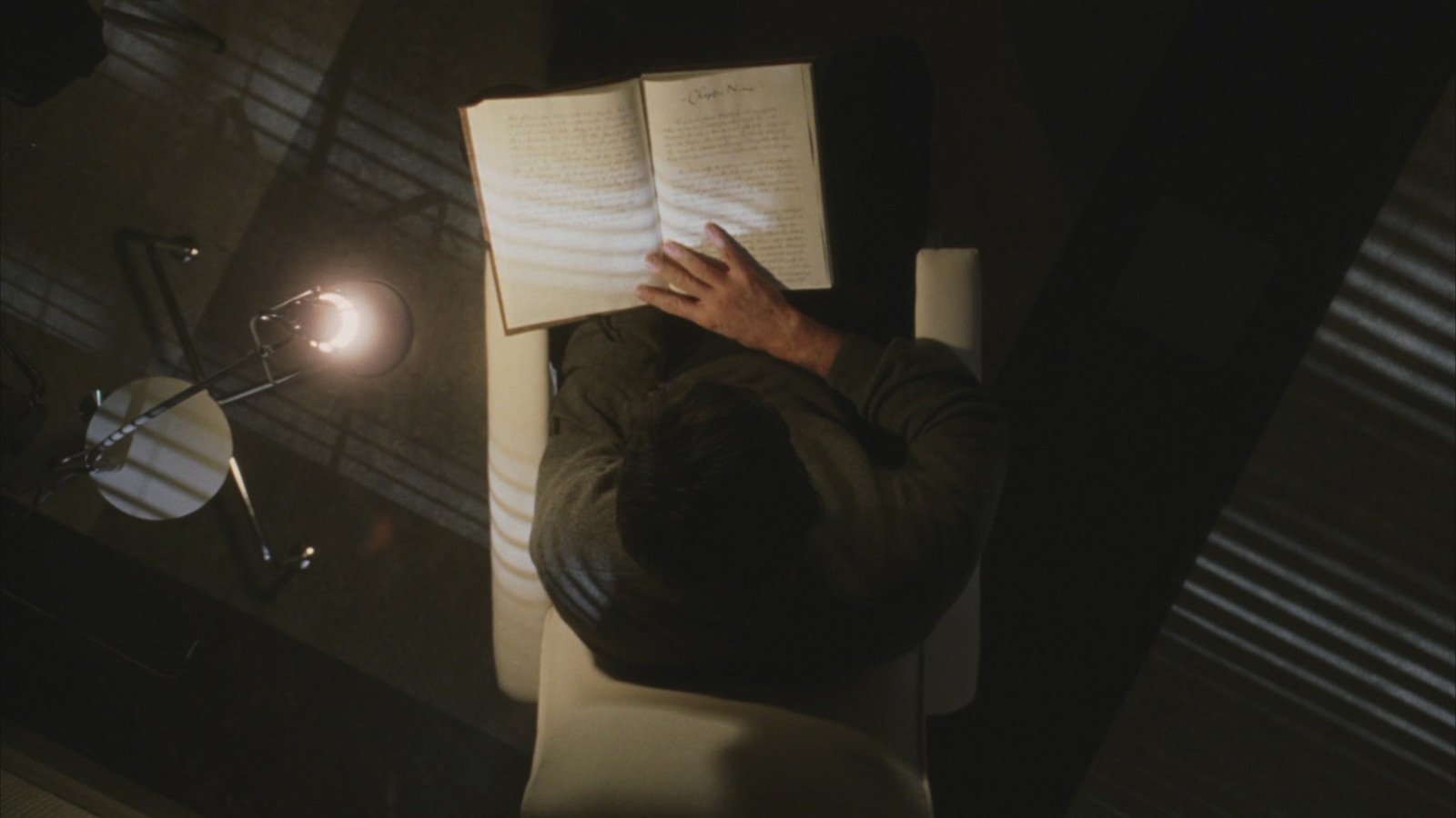 a man sitting in a chair reading a book