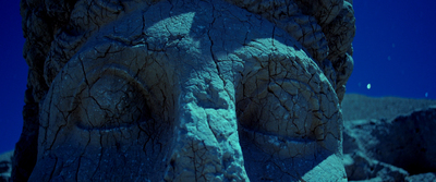 a close up of a stone statue with a sky background