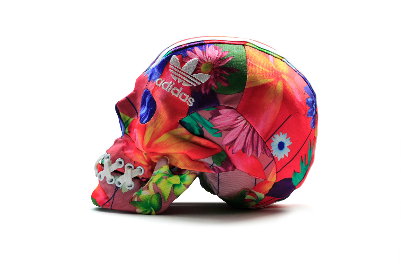 a multicolored skull with flowers and adidas on it