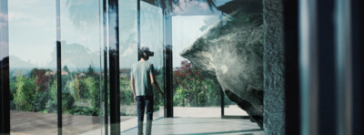 a man standing in front of a glass wall