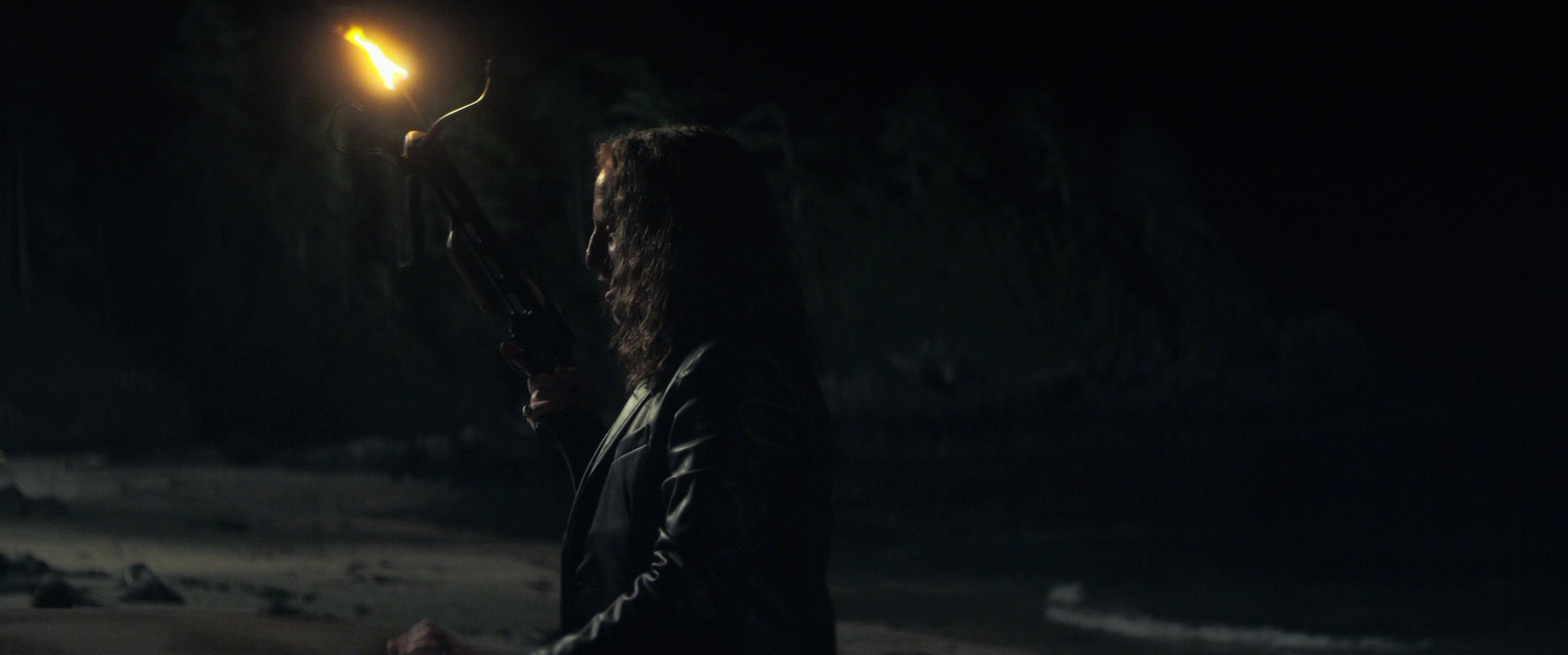 a woman holding a gun in the dark