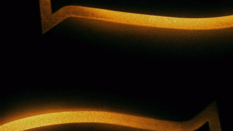 a black and yellow photo of a curved object