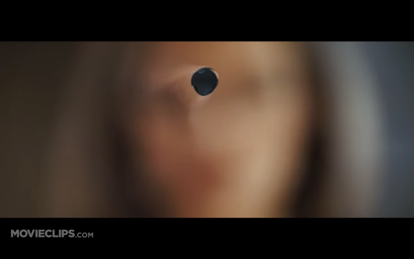 a blurry image of a woman's face with a hole in the middle