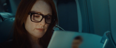 a woman wearing glasses looking at a tablet