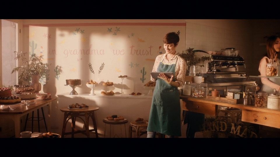 a woman standing in a kitchen next to a counter
