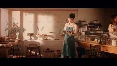a woman standing in a kitchen next to a counter