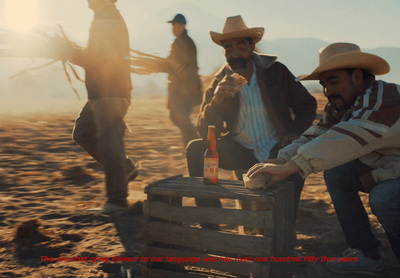 a group of men sitting on top of a wooden crate