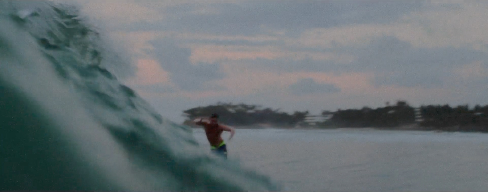 a man riding a wave on top of a surfboard