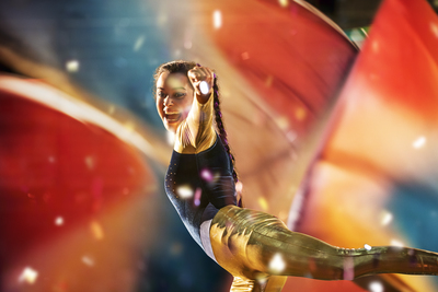 a woman is doing a trick on a surfboard