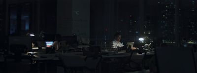 a man sitting at a table in a dark room