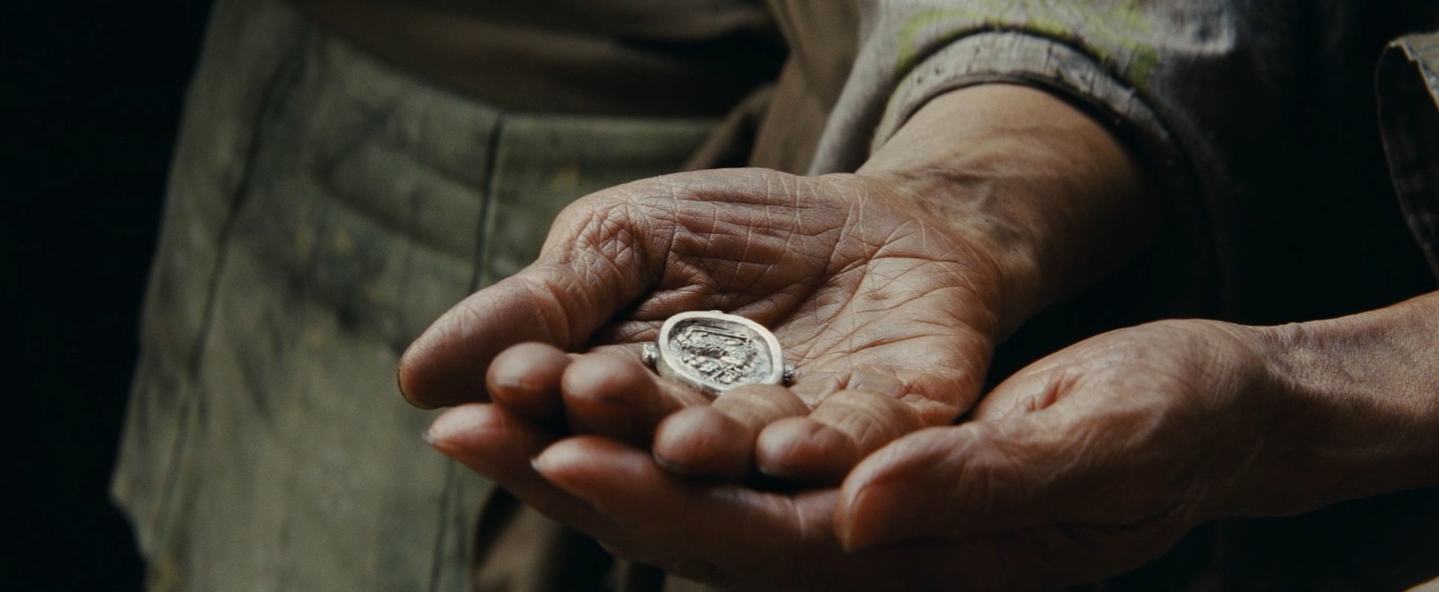 a person holding a coin in their hands