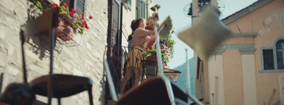 a group of people standing on a balcony next to a building