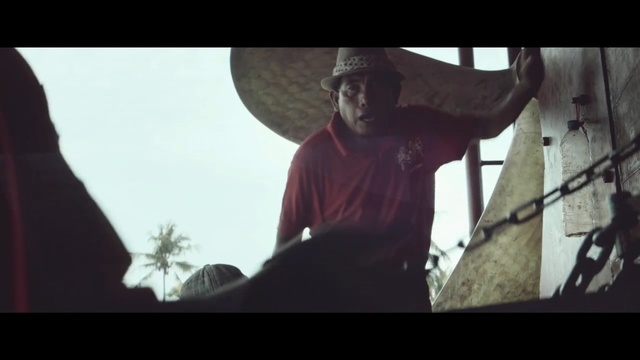 a man in a red shirt carrying a large object