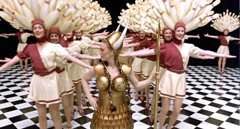 a group of women standing on top of a checkered floor