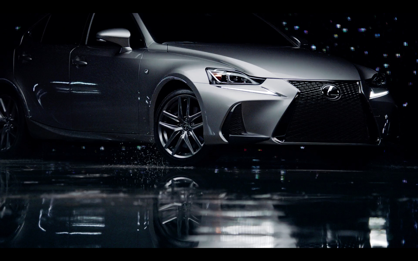 a silver car parked in a dark room