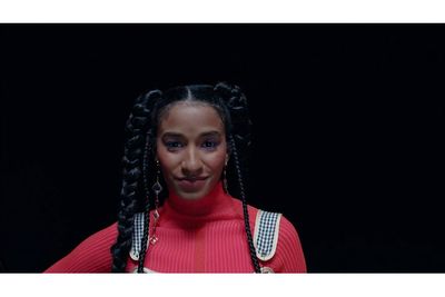 a woman with braids and a red sweater