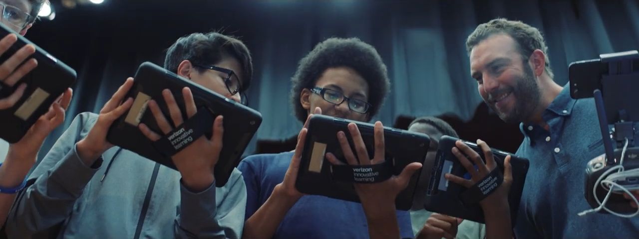 a group of people holding up their cell phones