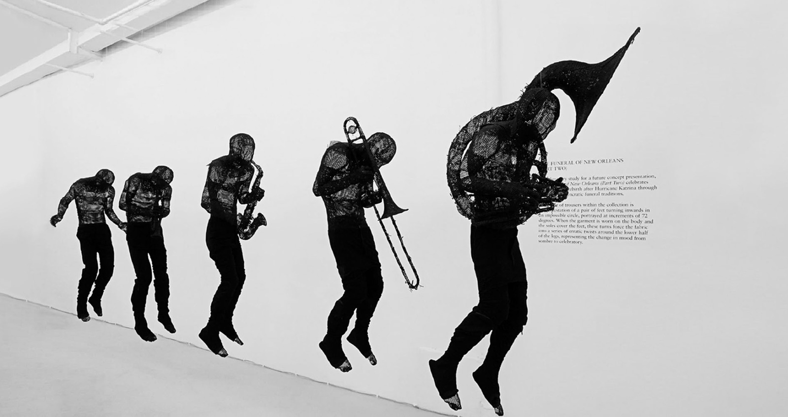 a black and white photo of a man with a trombone