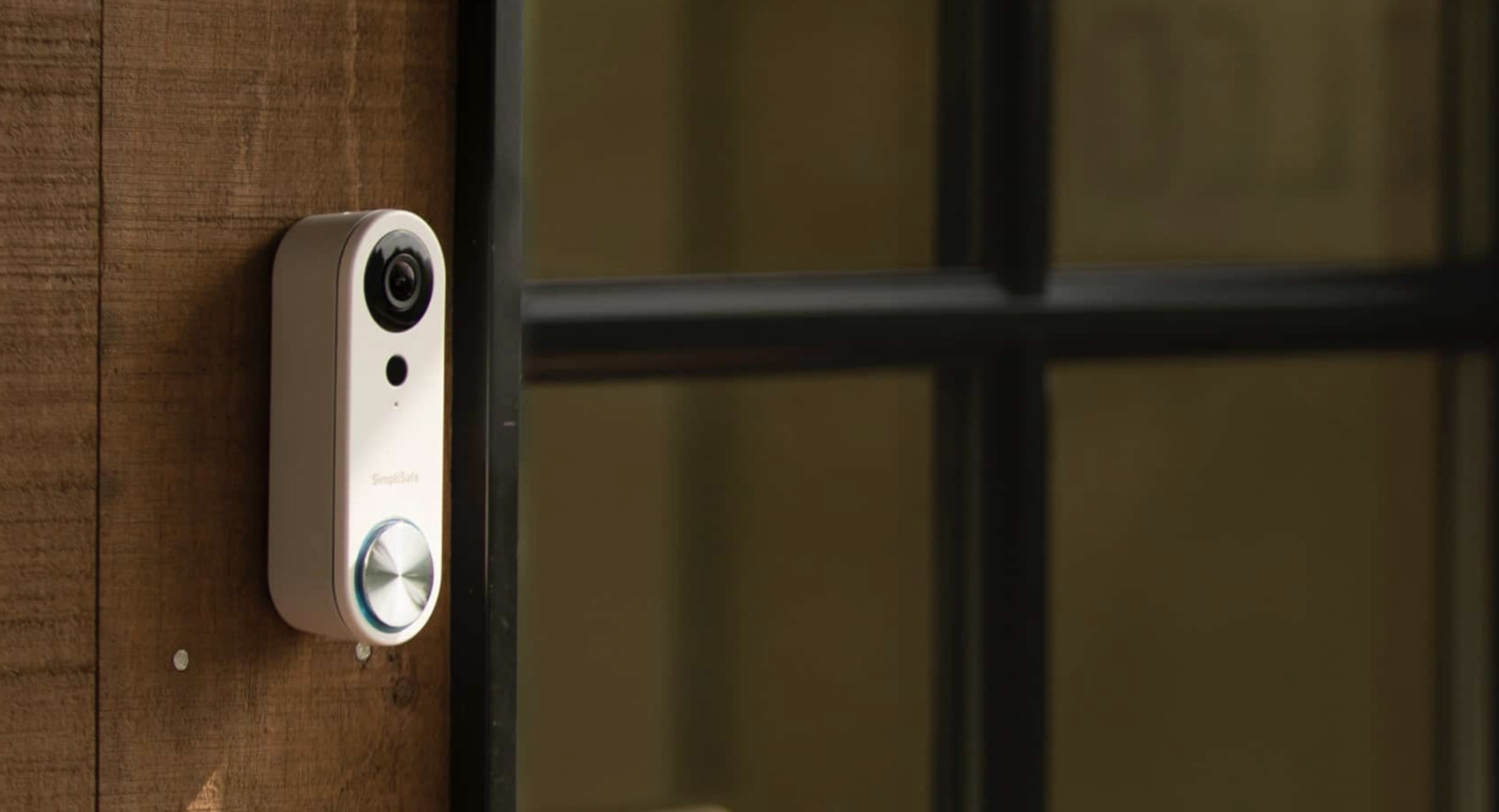 a security camera mounted on the side of a wooden door