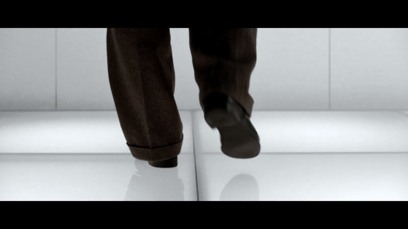 a person standing on a white tiled floor