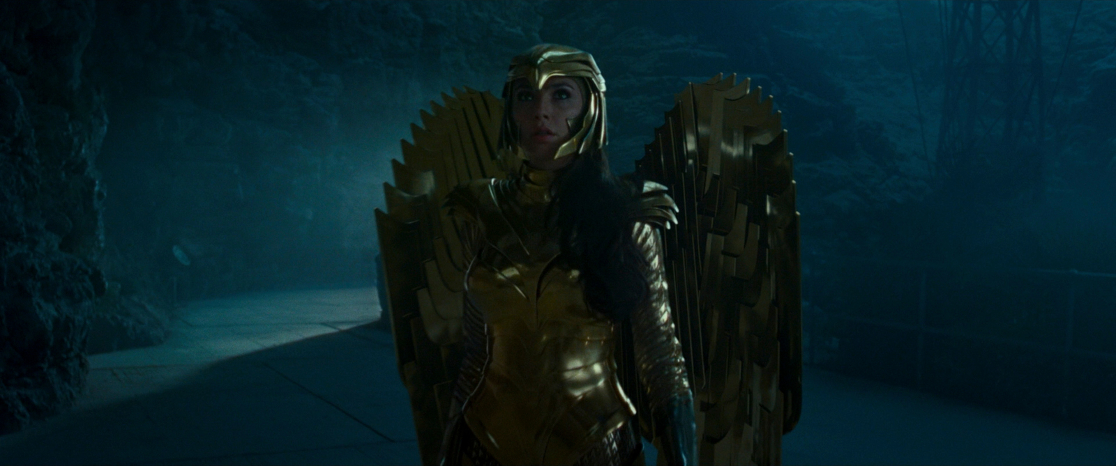 a woman dressed as a golden throne in a dark forest