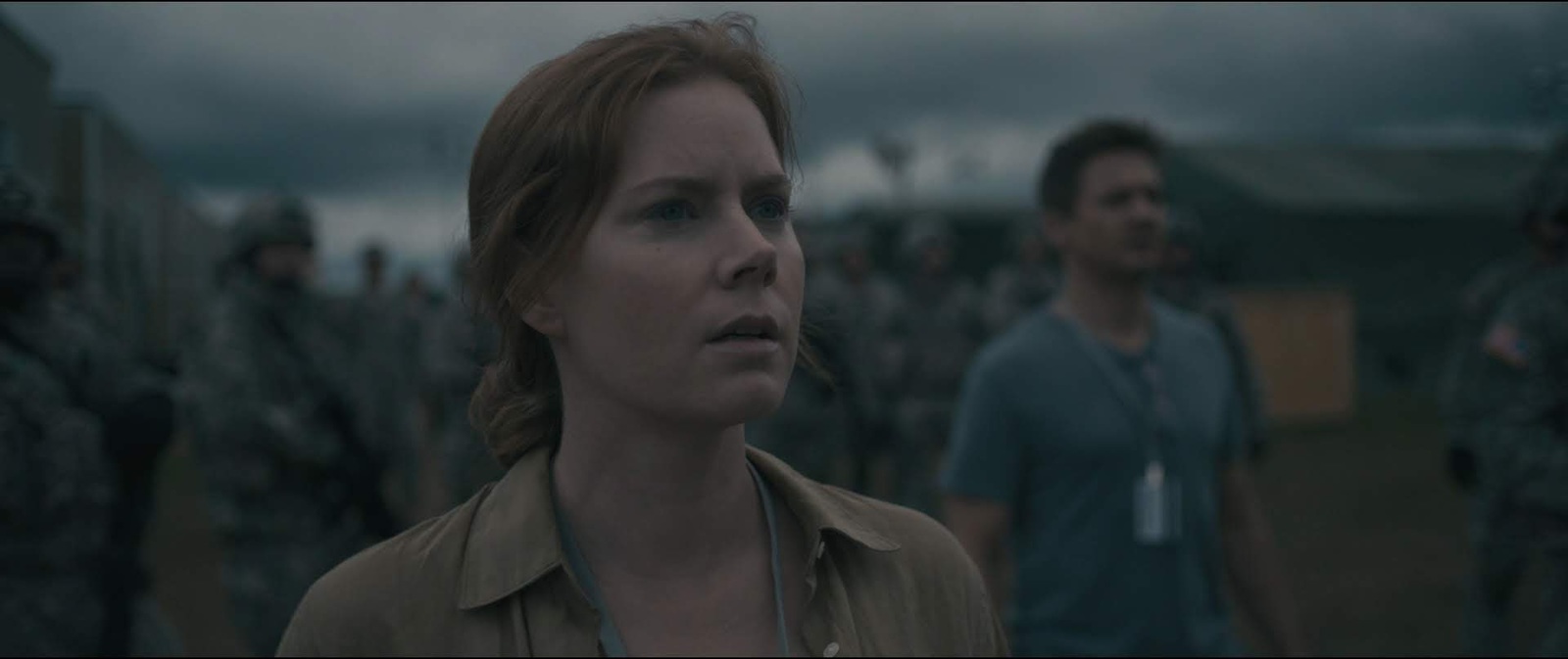 a woman standing in front of a group of soldiers