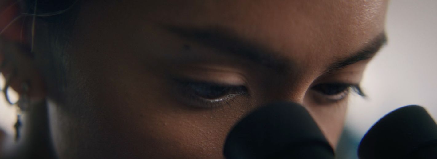 a close up of a person holding a cell phone to their ear