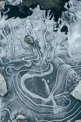 a close up of ice and rocks on the ground