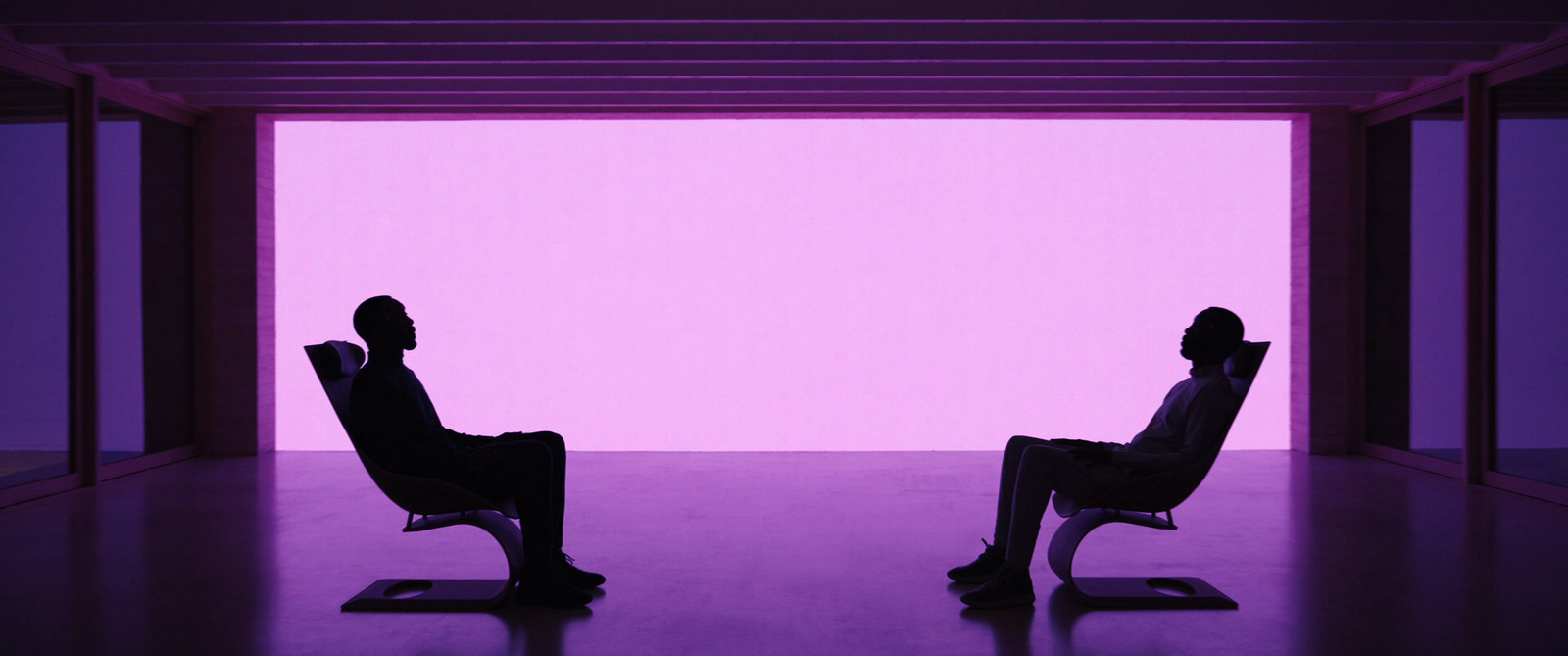 a couple of people sitting in chairs in a room