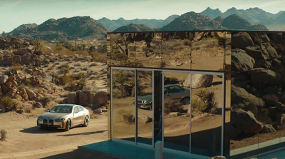 a car parked in front of a building in the desert