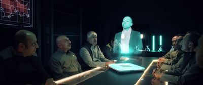 a group of people sitting around a table in a dark room