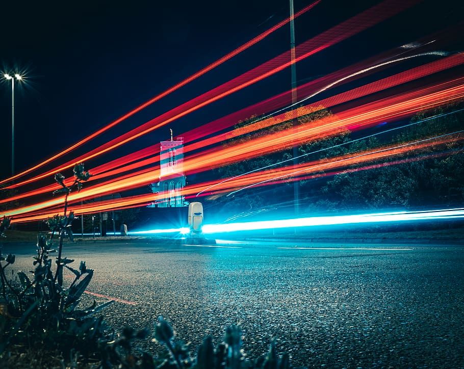 a long exposure photo of a street at night