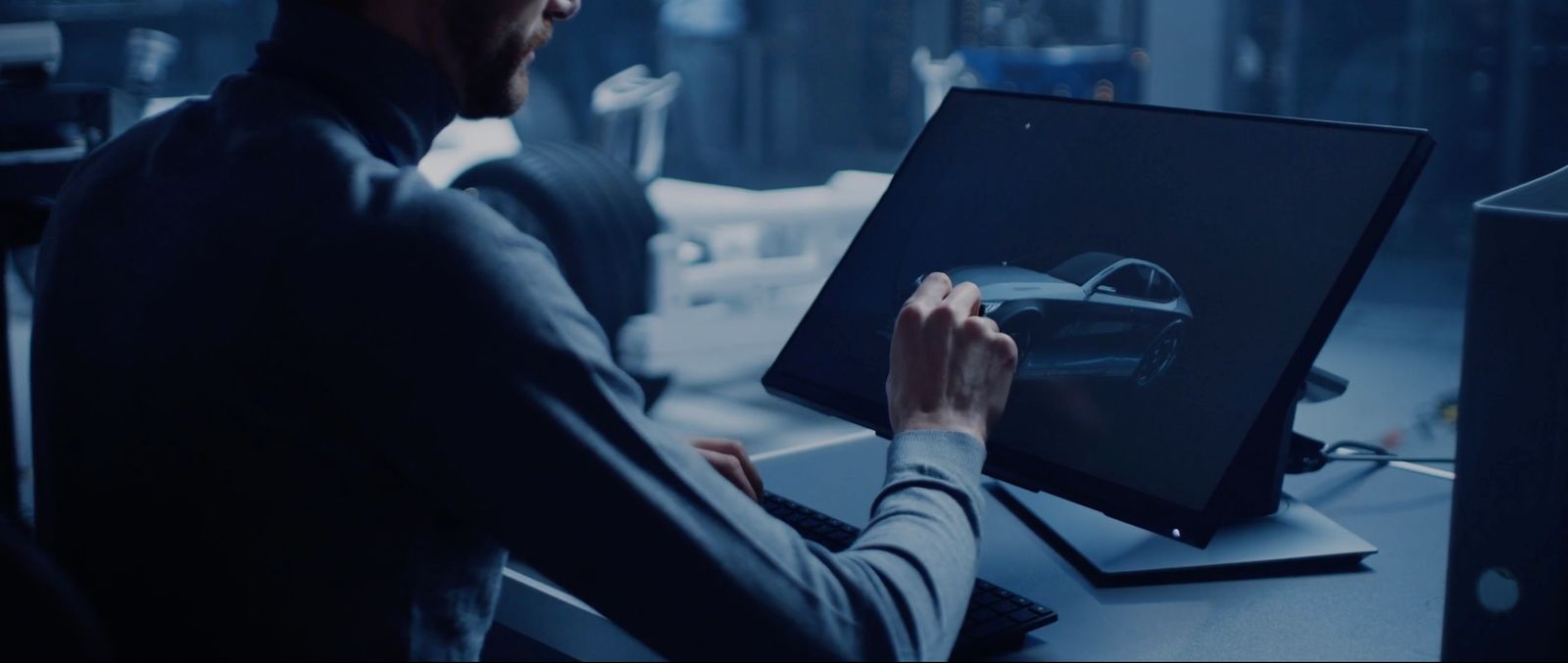 a man sitting in front of a computer screen