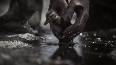 a close up of a person's hands in the water